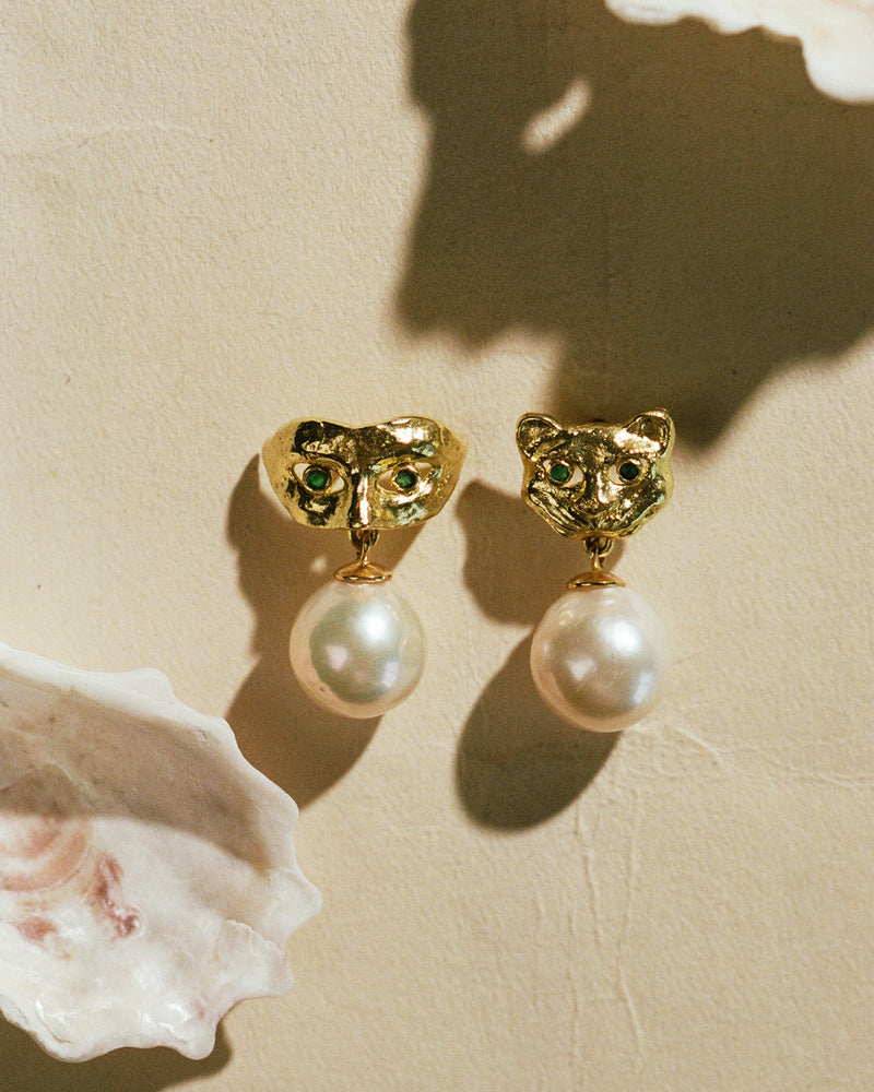 golden mask earrings with green eyes